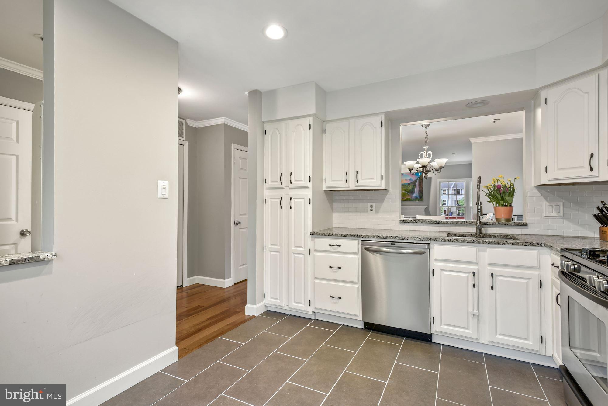 20121 Crew Square Ashburn, VA 20147 - Photo 9 of 36 a kitchen with white cabinets stainless steel appliances and a sink