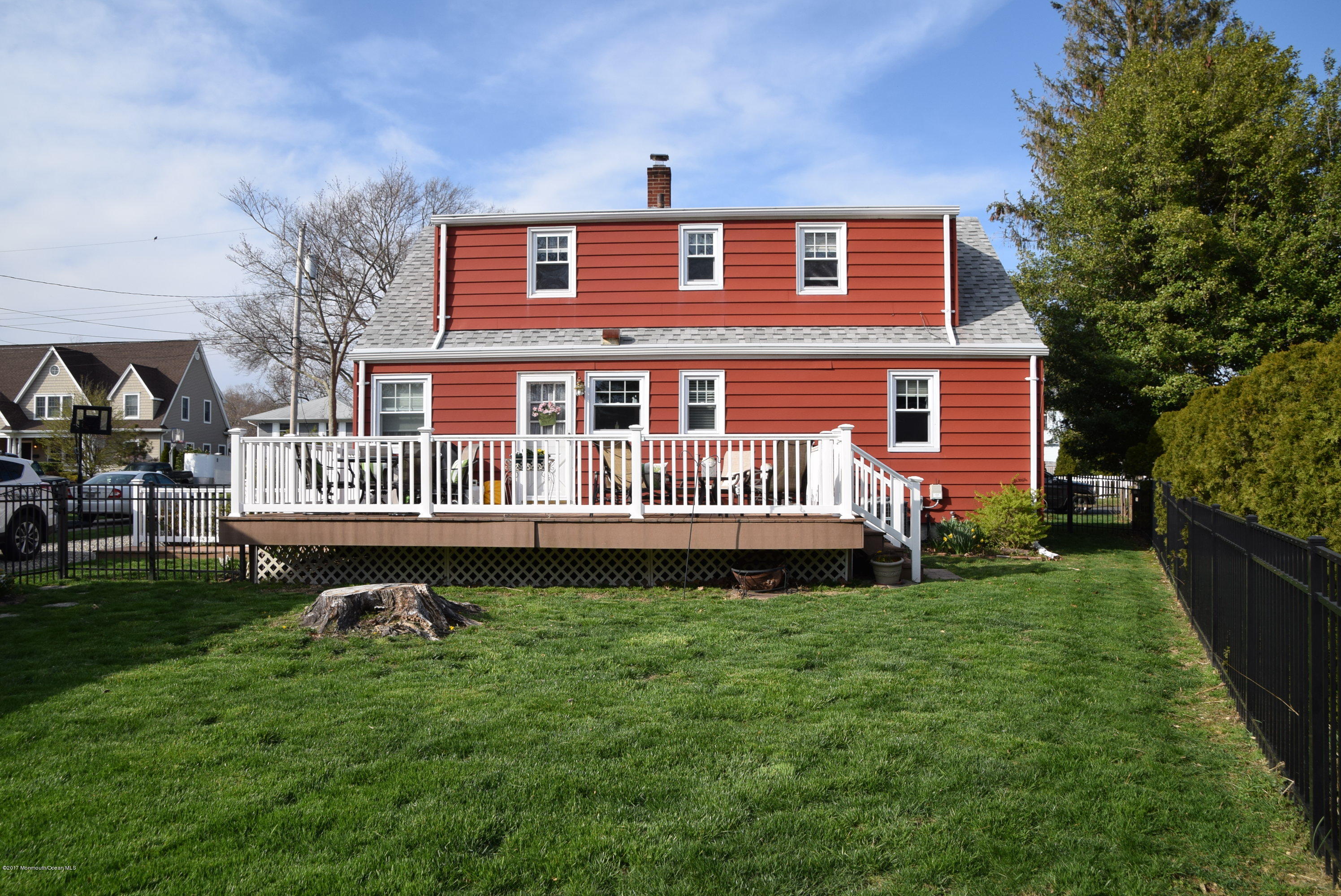51 Narrumson Road Manasquan, NJ 08736 - Photo 3 of 17 a front view of a house with a garden and deck
