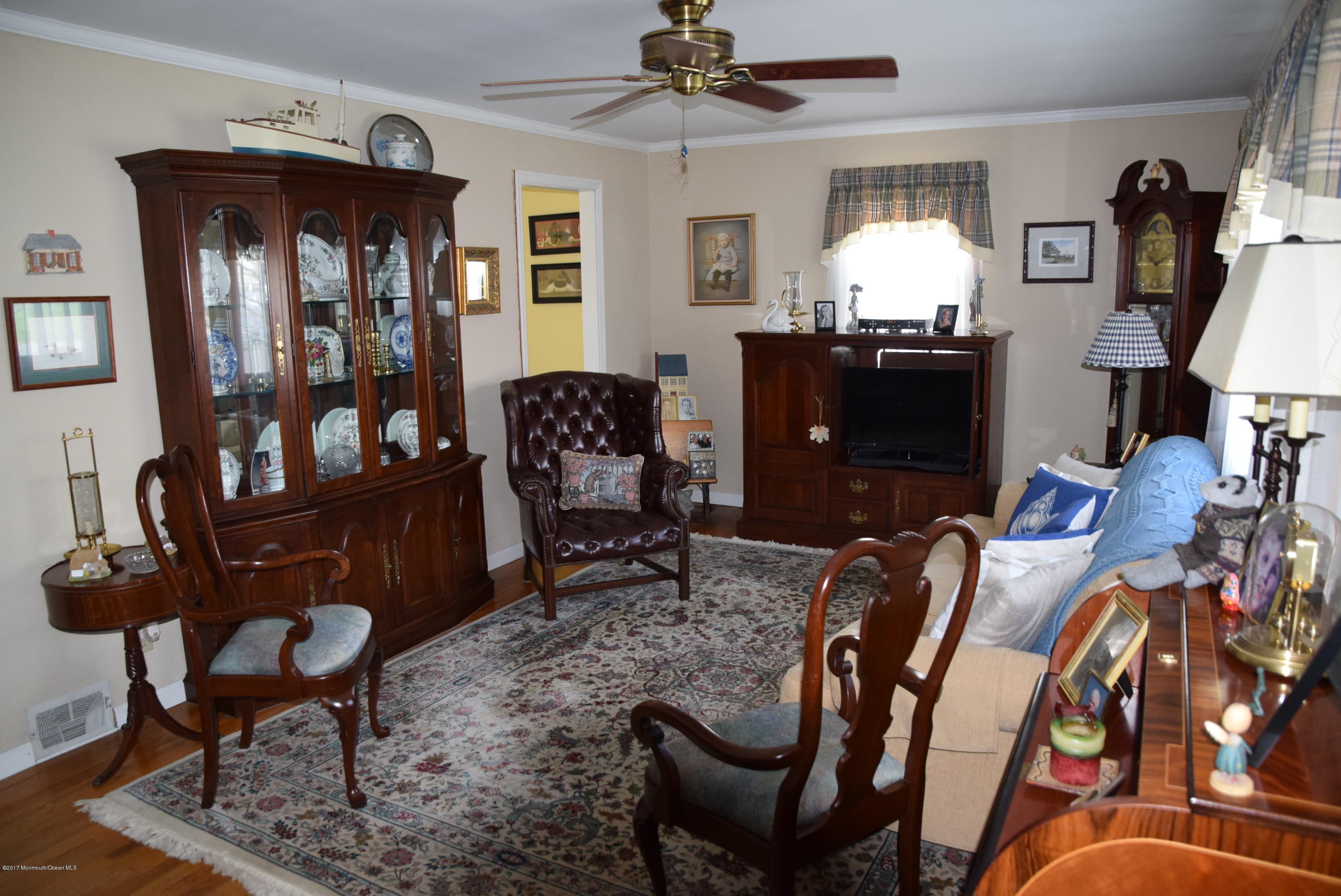 51 Narrumson Road Manasquan, NJ 08736 - Photo 7 of 17 a living room with furniture a piano and a bookshelf