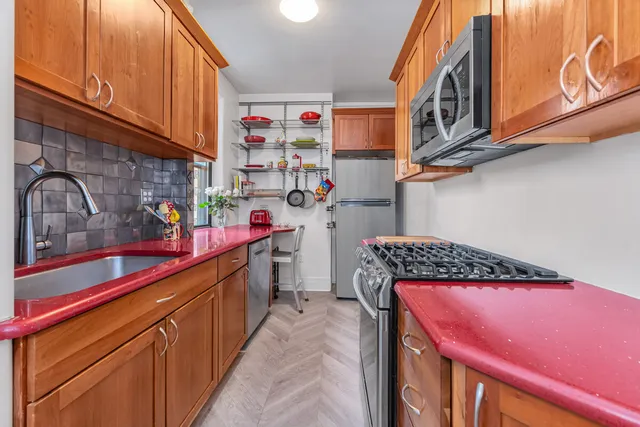 a kitchen with stainless steel appliances granite countertop a sink and cabinets