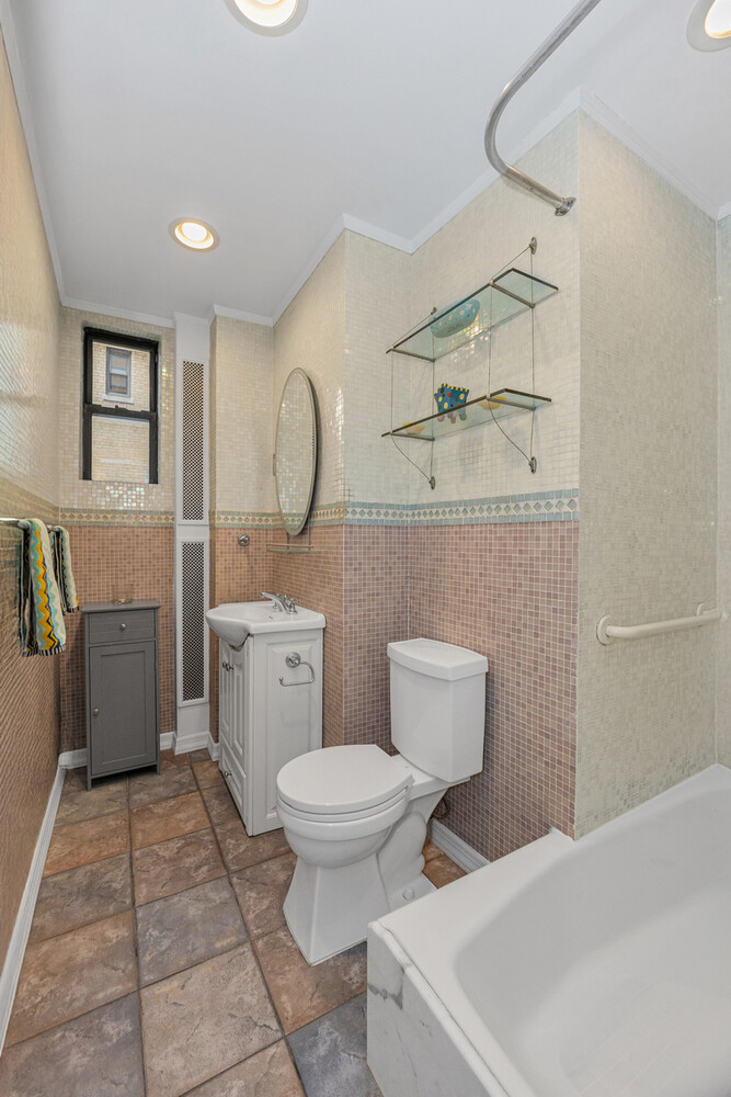 46 West 95th Street, Unit 7C Manhattan, NY 10025 - Photo 8 of 11 a bathroom with a toilet sink vanity and mirror