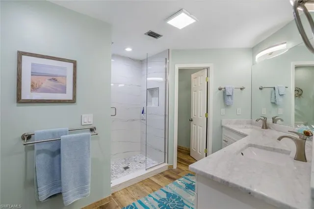 a bathroom with a shower sink and mirror