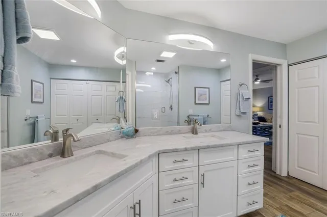 a spacious bathroom with a granite countertop sink mirror and shower