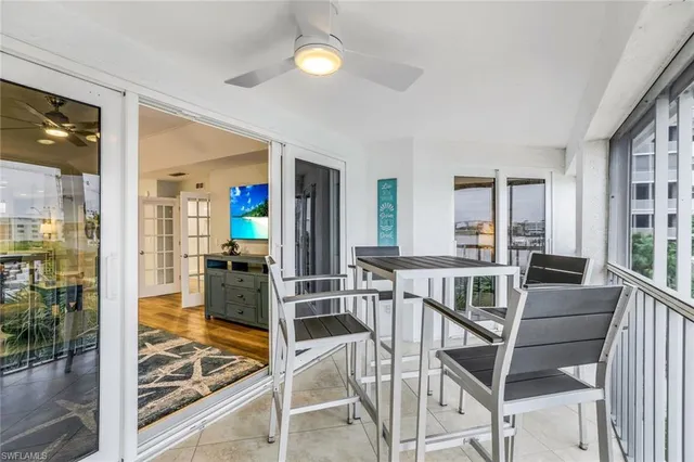 a view of a livingroom with furniture and floor to ceiling window
