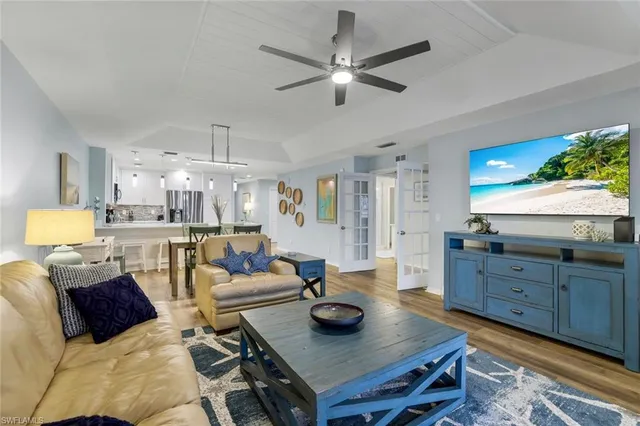 a living room with furniture and a chandelier
