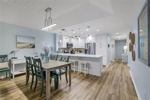 a large kitchen with a table and chairs