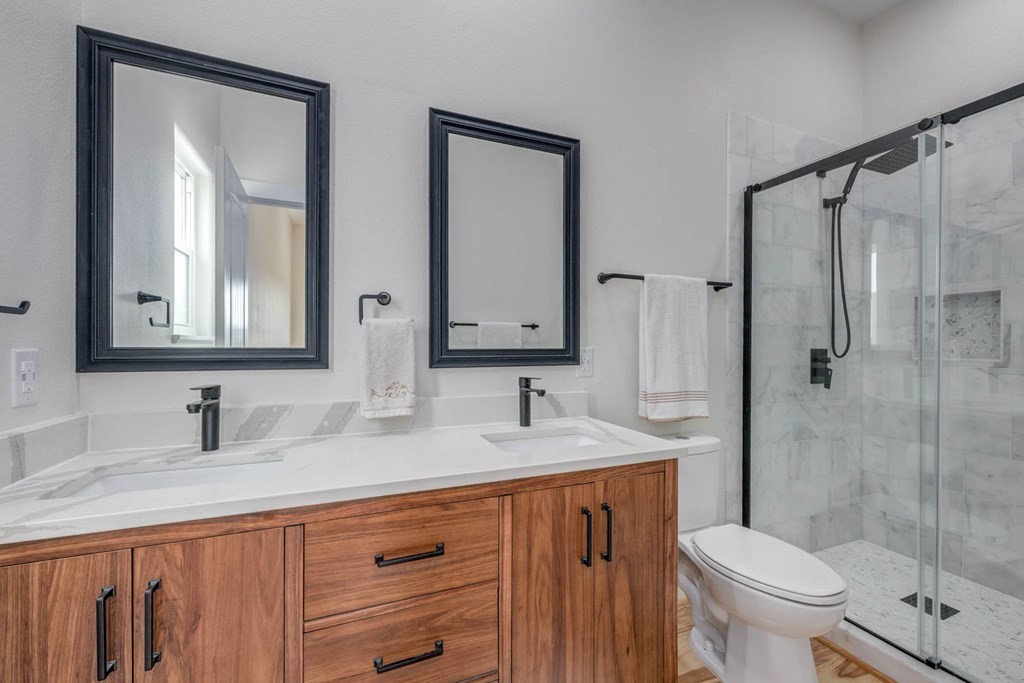 13-14 Bayview Loop Rockport, TX 78382 - Photo 20 of 26 a bathroom with a double vanity sink toilet and shower