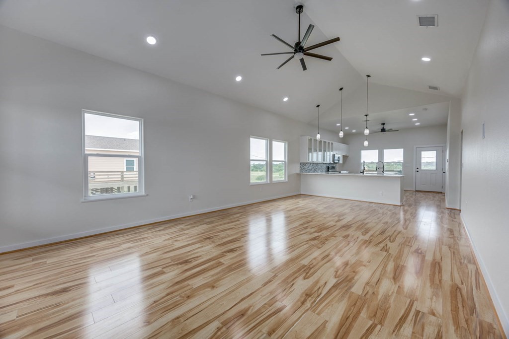 13-14 Bayview Loop Rockport, TX 78382 - Photo 6 of 26 a view of an empty room and kitchen view with wooden floor
