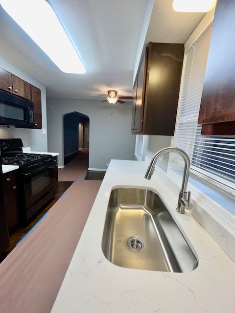 2227 Forest Avenue North Riverside, IL 60546 - Photo 2 of 12 a kitchen with a sink a microwave and cabinets