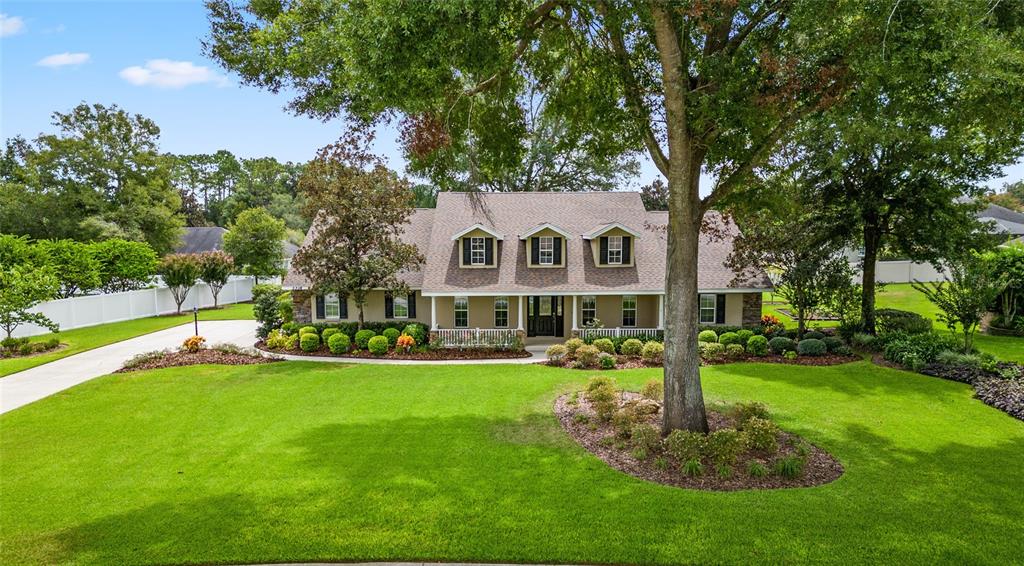 a front view of a house with a yard porch and green space