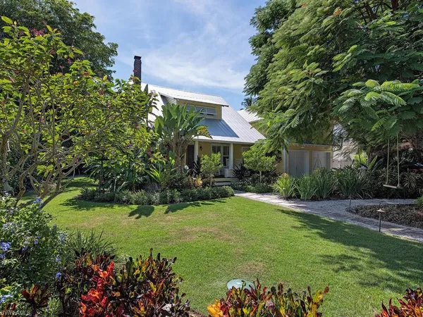 a view of a house with a yard and garden