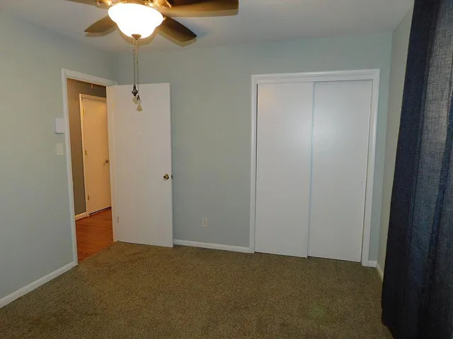 an empty room with closet area