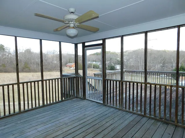 a view of a balcony with wooden floor