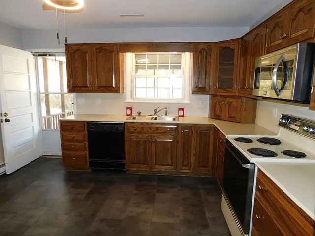 a kitchen that has a sink and a stove in it
