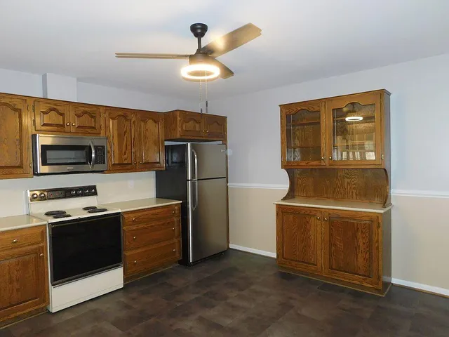 a kitchen with stainless steel appliances a stove microwave and refrigerator