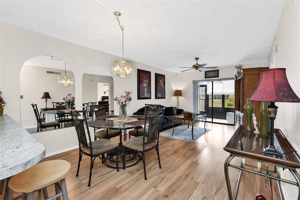 25225 Rampart Boulevard, Unit 1604 Punta Gorda, FL 33983 - Photo 7 of 41 a view of a dining room with furniture a chandelier and wooden floor
