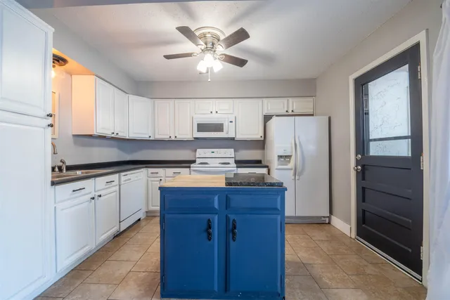 a kitchen with granite countertop cabinets and stainless steel appliances