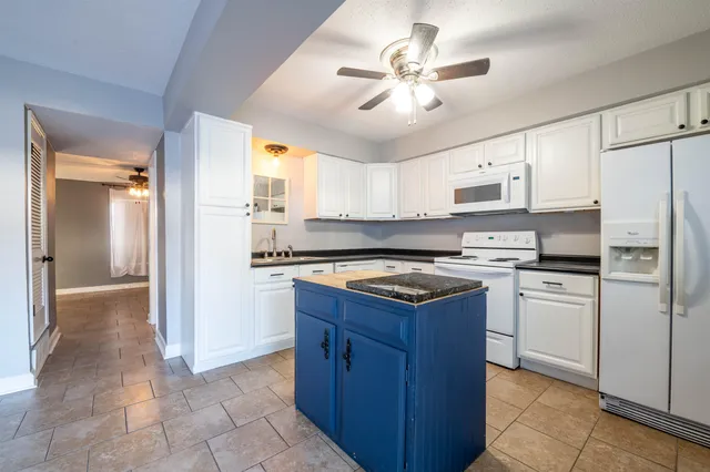a kitchen with a refrigerator a sink and cabinets