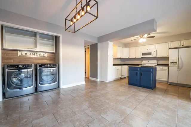 a kitchen with stainless steel appliances granite countertop a refrigerator and a stove