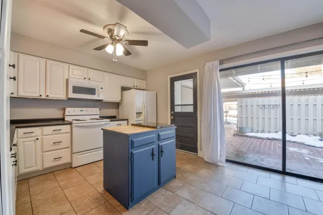 a kitchen with a stove a sink and a refrigerator