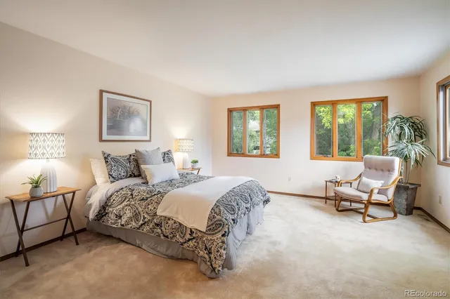 a spacious bedroom with a bed and a couch