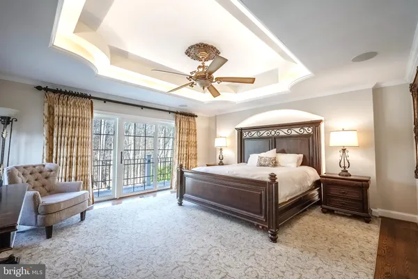 a spacious bedroom with a bed and a chandelier