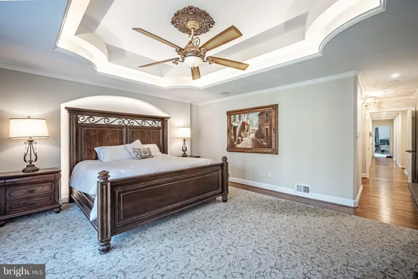 a bedroom with a bed and a chandelier