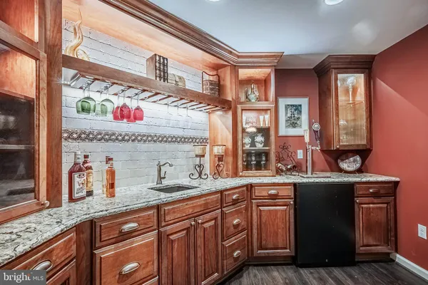 a room with lots of wooden furniture and large windows