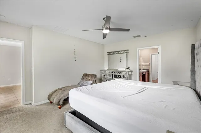 a bedroom with a bed and ceiling fan