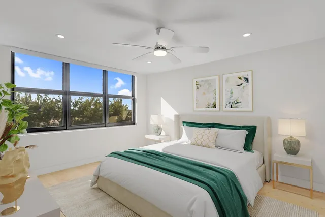 a bedroom with a large bed and a window