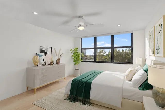 a bedroom with a large bed and a window