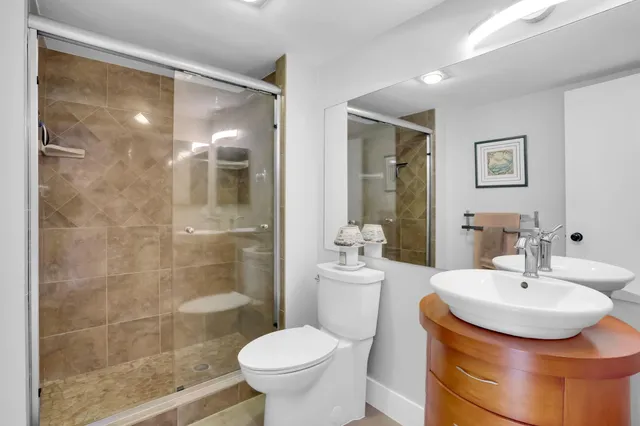 a bathroom with a sink toilet and shower