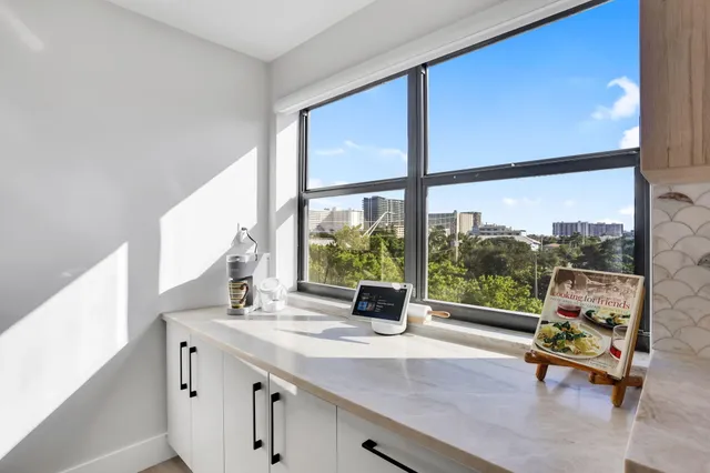 a living room with a large window and table