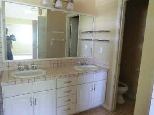 4439 Kaloloku Road, Unit A Kapaa, HI 96746 - Photo 6 of 17 a bathroom with a granite countertop sink and a mirror