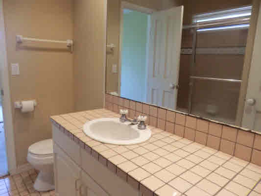 4439 Kaloloku Road, Unit A Kapaa, HI 96746 - Photo 10 of 17 a bathroom with a sink vanity and toilet