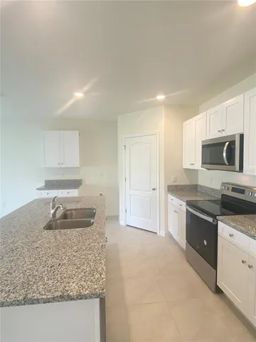 a kitchen that has a sink and a stove in it