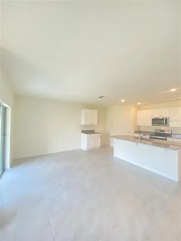 a view of a kitchen with a sink and a stove top oven