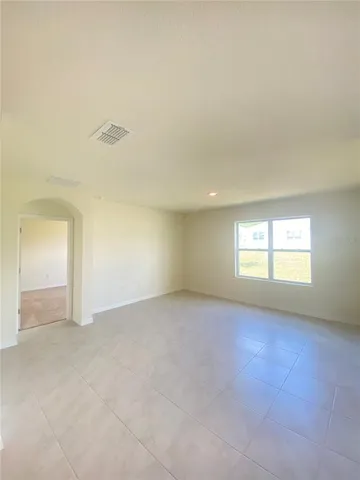 an empty room with a empty space and windows