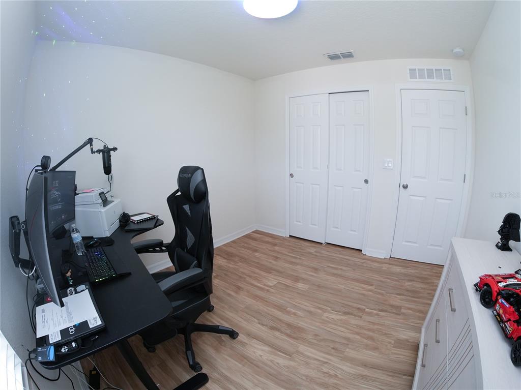 2451 Varenna Loop Kissimmee, FL 34741 - Photo 6 of 11 a view of a room with gym equipment