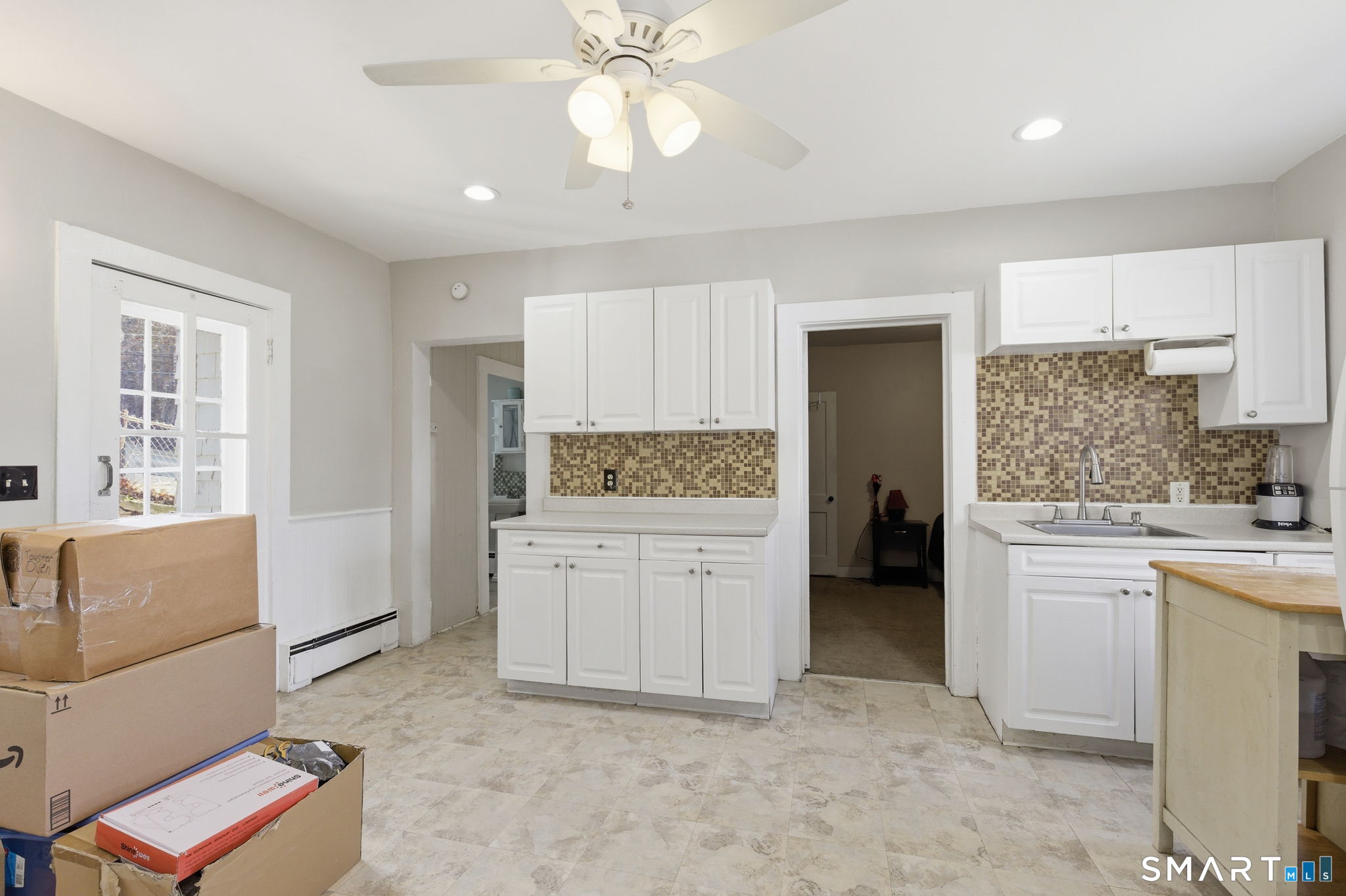Undisclosed Address Vernon, CT 06066 - Photo 15 of 31 a kitchen with white cabinets and white appliances