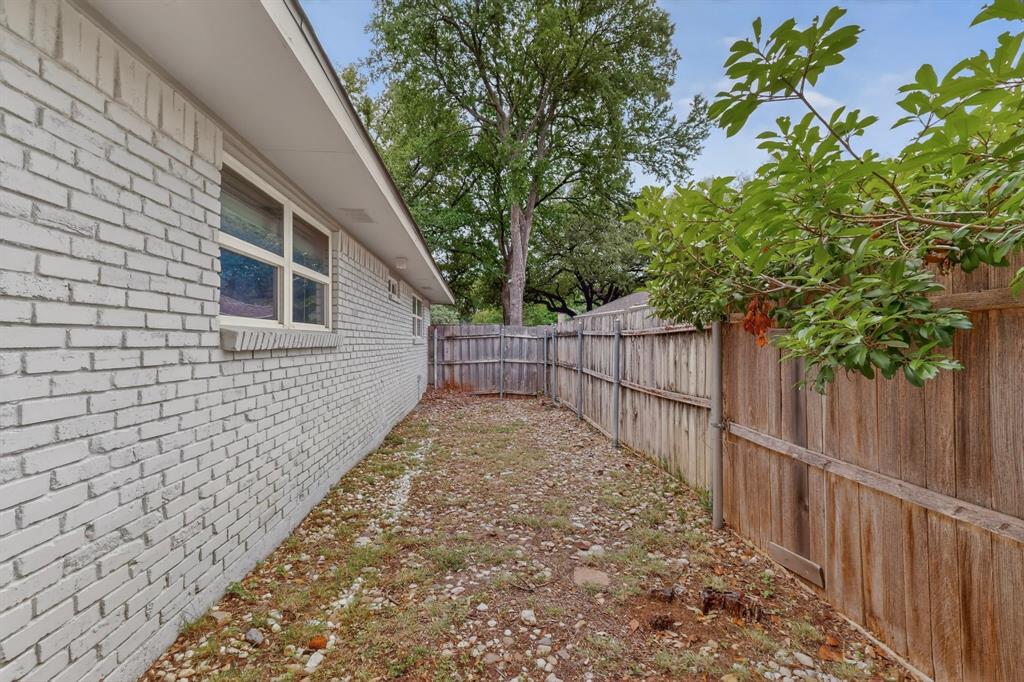 7631 Meadow Road Dallas, TX 75230 - Photo 38 of 40 The yard with a wooden fence