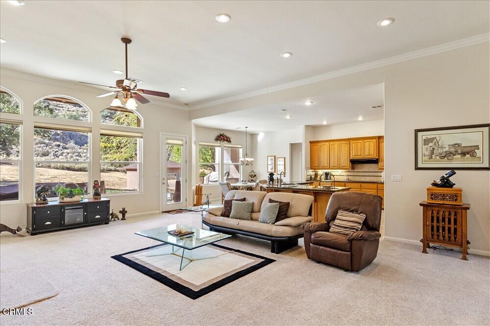 26450 Cumberland Road Tehachapi, CA 93561 - Photo 12 of 52 a living room with furniture a chandelier and a window