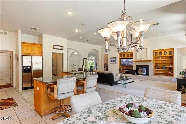 a large kitchen with stainless steel appliances granite countertop a refrigerator and a sink