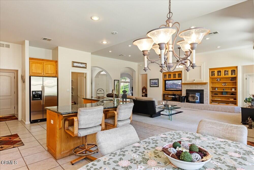 26450 Cumberland Road Tehachapi, CA 93561 - Photo 17 of 52 a living room with fireplace furniture and a chandelier