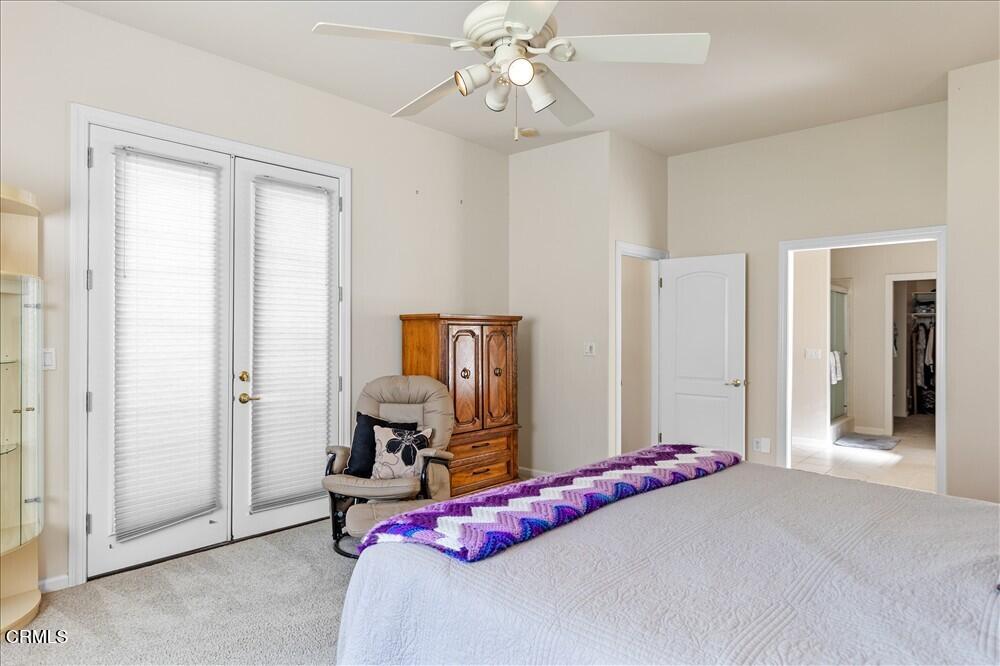 26450 Cumberland Road Tehachapi, CA 93561 - Photo 35 of 52 a bedroom with a bed and a chandelier