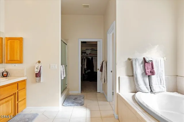 a bathroom with a tub sink and mirror