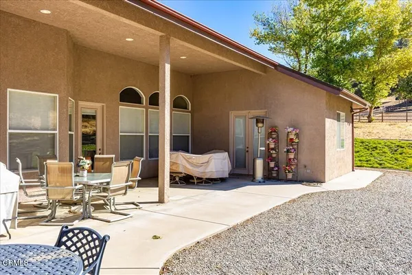 a view of a house with a backyard