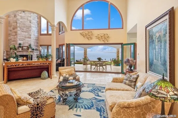 a living room with furniture and a floor to ceiling window