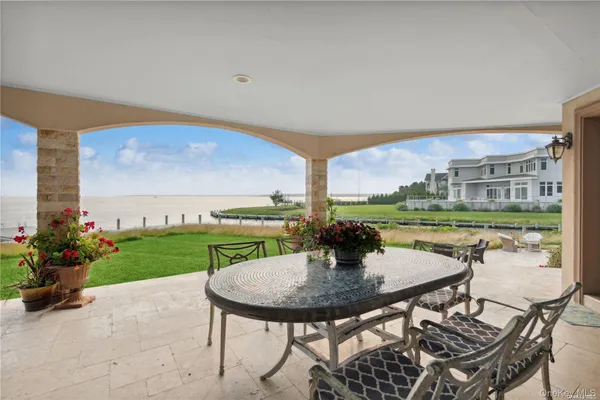 a view of a patio with a table and chairs