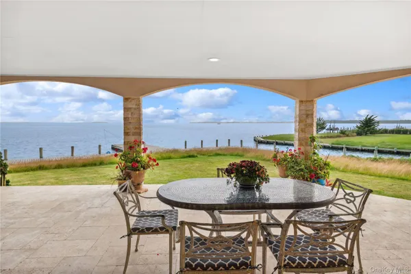 a view of a swimming pool and outdoor seating